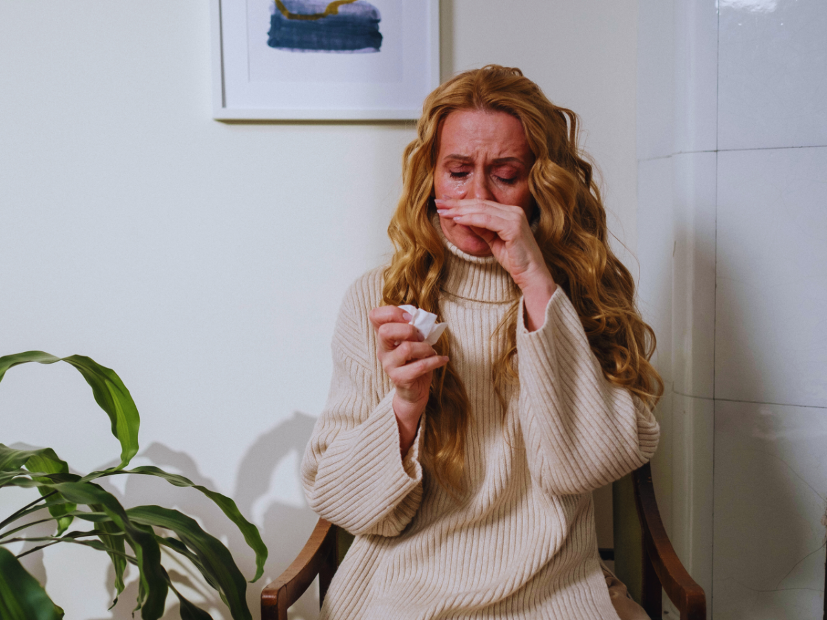 Woman suffering from allergies caused by poor indoor air quality 