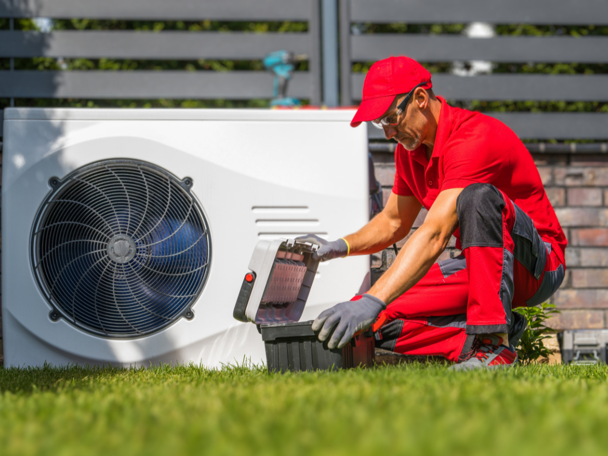 HVAC tech performing annual heat pump maintenance