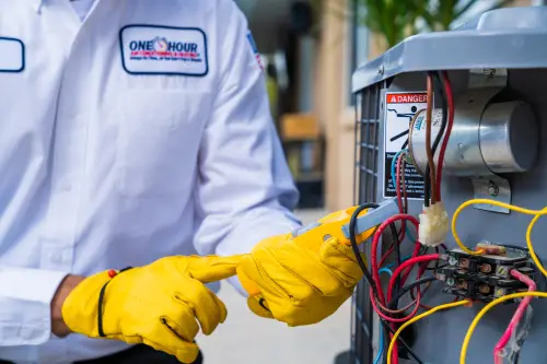 One Hour Tech Working on AC Unit Outside close up of Clamp Meter