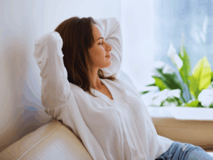 woman on couch enjoying improved indoor air quality